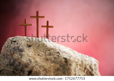 Three crosses against red sky on Calvary hill background. Crucifixion, resurrection of Jesus Christ. Christian Easter holiday, Golgotha. He risen and alive. Jesus is the reason. Gospel, salvation.