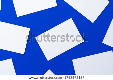 Blank white businesscards on classic blue background Royalty-Free Stock Photo #1752692189