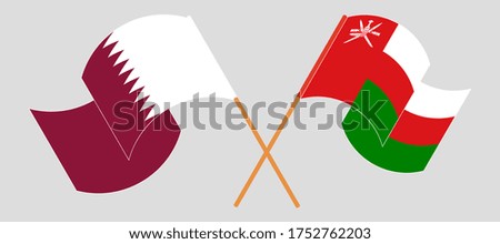 Crossed flags of Oman and Qatar