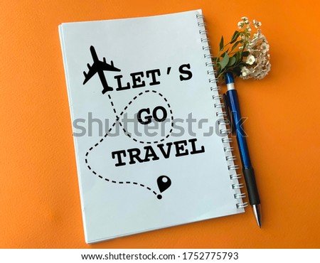 in a white notebook a plane is drawn and written let’s go travel. Image for travel agency. the concept of travel after quarantine