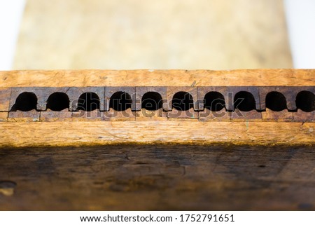 Part of a wooden cigar filling machine, measuring the thickness and length of the tobacco Royalty-Free Stock Photo #1752791651