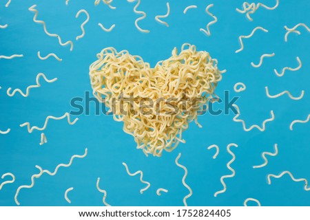 instant noodles advertisement photo. levitated noodle heart symbol over blue trendy background. outer space. for design and ornate. love fast food concept. Royalty-Free Stock Photo #1752824405