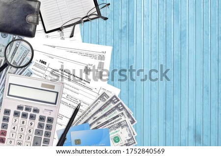 IRS form 1065 U.S. Return of partnership income lies on flat lay office table and ready to fill. U.S. Internal revenue services paperwork concept. Time to pay taxes in United States. Top view Royalty-Free Stock Photo #1752840569