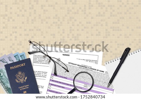 Department of State form DS60 Affidavit Regarding a change of name lies on table and ready to fill. Paperwork during operations with US Passport concept. Flat lay top view Royalty-Free Stock Photo #1752840734