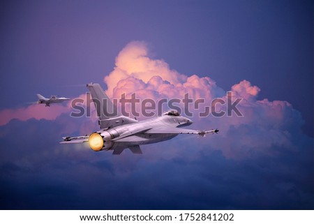 F-16 Fighting Falcon jets (models) fly toward pink and purple clouds at dusk Royalty-Free Stock Photo #1752841202