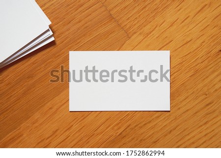 Business card on wooden background. Blank name card for company logo,  Branding Mock-up. Flat lay. Copy space for text                               