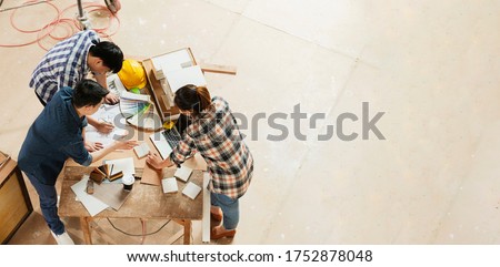 top view of group of smart asian architect interior design team consulting with constrction engineer work brainstrom  meeting with house project blueprint and home mockup in house renovation structure Royalty-Free Stock Photo #1752878048