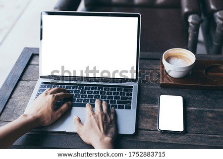 computer,cell phone mockup image.hand woman work using laptop texting mobile.blank screen with white background for advertising,contact business search information on desk in cafe.marketing,design