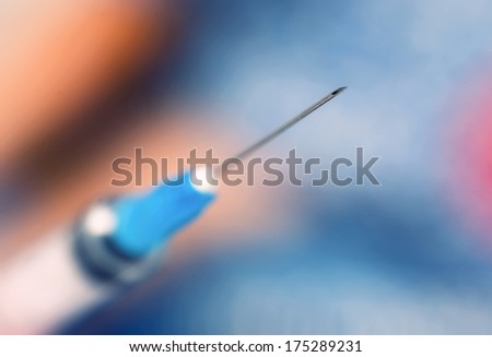 Macro photography of a syringe at blue background