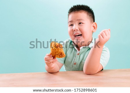 Lovely boy eating Fried chicken