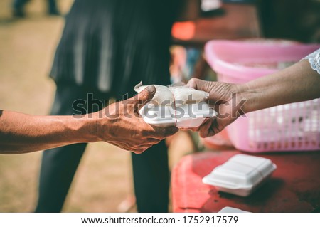 Providing free food for the poor hunger : concept of feeding, helping and sharing Royalty-Free Stock Photo #1752917579