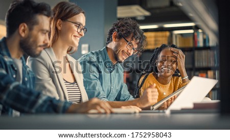 Diverse Team of Young Brilliant Entrepreneurs and Office Specialists Have a Meeting, Talking, Using Digital Tablet Computer, Finding Solutions and Solving Problems. Talented Young People Working Royalty-Free Stock Photo #1752958043