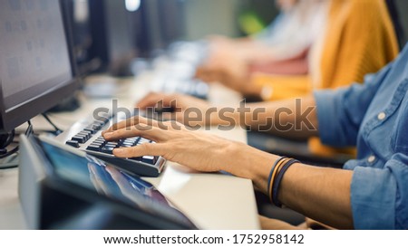 Row of Diverse Group of Multi-Ethnic People Works on PC. Office Team of Technical Support Staff Members Work on Computers, Help People Find Solutions. Camera Shot focus On Hands Royalty-Free Stock Photo #1752958142