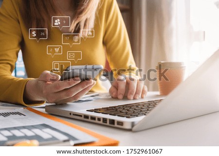Social media and Marketing virtual icons screen of business women typing keyboard with laptop computer and smart phone at office.
