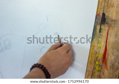 hand drawing a picture, man drawing a picture