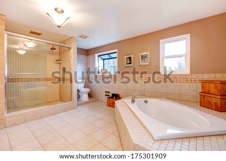 Large bathroom with glass door shower and bath tub
