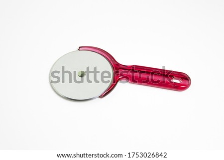Stainless steel pizza cutter with handle isolated on gray background. Kitchen utensil. High-resolution photo.Top view.