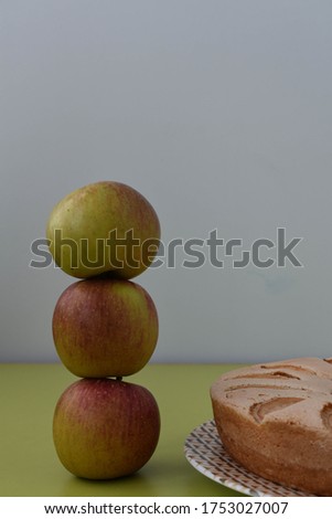 Pyramid of apples on a gray background. Apple sponge cake. Copy space