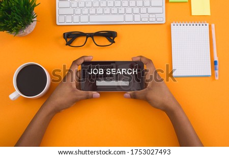 Employment Concept. Above top view of black woman holding smart phone with job search engine app on screen, isolated