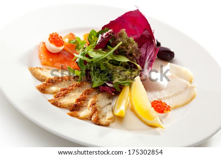 Fish Dish with Lemon, Fresh Green Leaves and Olives