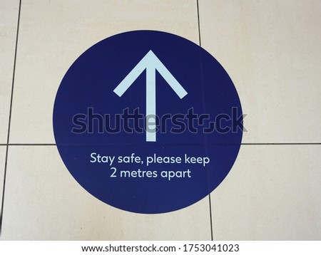 "Stay Safe, Please Keep 2 Metres Apart" pedestrian directional one way floor sign. 