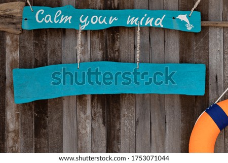 Sign with text calm your mind on old wooden background. Summer vacations on paradise island concept. Tropical beach banner