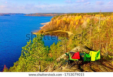 On a bright sunny day two sun loungers are installed on a cliff above the bay for resting on nature, View of Karelia beautiful nature 