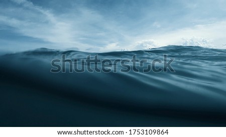 Wave on moving water surface close up in the middle of the screen.  Under Water Surface in the middle of the sea Royalty-Free Stock Photo #1753109864