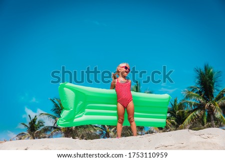 cute little girl go swim on tropical beach