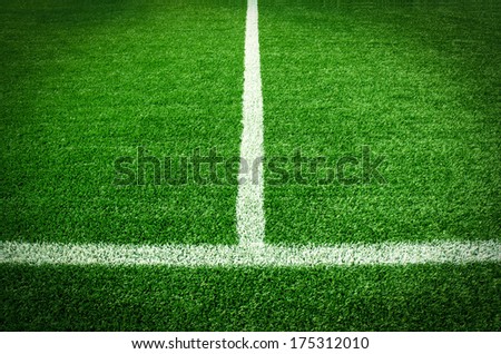 Artificial green turf texture background with white line marks