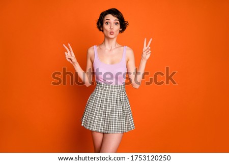 Portrait of cute sweet girlish lady have spring weekend walk make v-sign send air kiss wear singlet plaid clothes isolated over bright color background