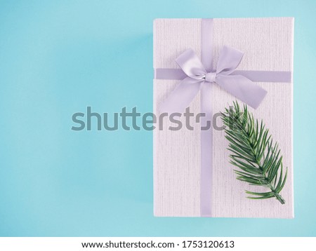 Gifts and christmas decorations on light blue background. Space for text.