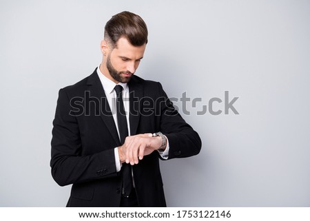 Portrait of serious concentrated man appoint meeting with his clients wait check time on wrist watch wear formalwear outfit isolated over grey color background