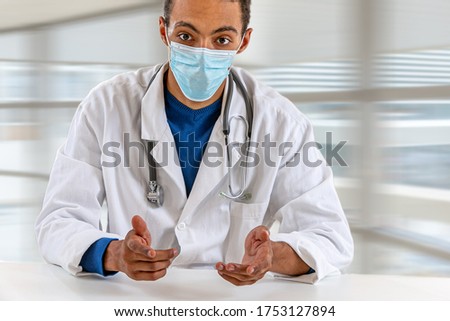 African-American black doctor man provides distant consultation to patient by video call, share useful info about corona virus pandemic infection outbreak concept. Royalty-Free Stock Photo #1753127894