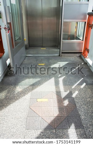 social distancing sign on the floor in front of an elevator for protecting covid-19 pandemic spreadand also new normal