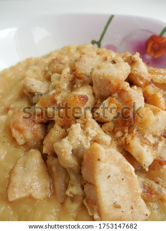 Background with fried pieces of chicken with pea porridge in a porcelain plate.