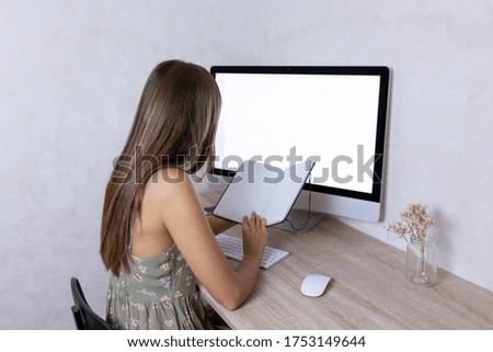 Young caucasian woman employee looking at his notebook during working day in home office. Working from home