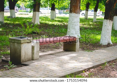 red bench made of wood and concrete in the Park