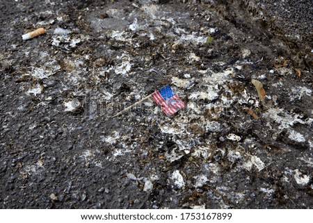 US Flag on dirty ground