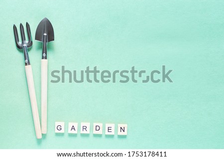 The decorating letters garden outdoors in the garden. Gardening at home. Flatlay on a green background. Tools for gardening at home. Growing food on windowsill. Copyspace for text, top view.