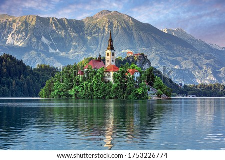 Sunrise over Bled Lake, Island, Church And Castle With Mountain Range (Stol, Vrtaca, Begunjscica) In The Background-Bled, Slovenia Royalty-Free Stock Photo #1753226774