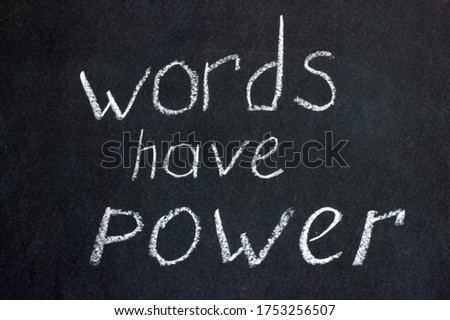 Words on a dark board with white chalk: "words have power." The slogan of freelancers and copywriters and not only