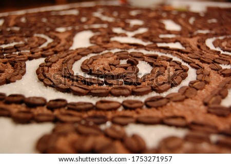 Beautiful background with the composition of coffee and sugar in the form of a pattern. Handwork.