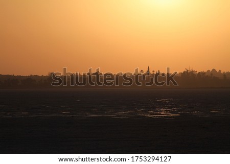 Golden sunset sky above cityscape of exotic Arabic town