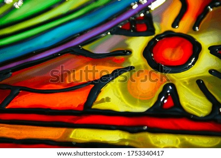 A luminous stained glass pattern is laid out on the glass. Red, blue, green, yellow, violet colors.