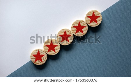 Wood circles with star sign on paper blue and white background, copy space. Business concept success process. Quality and luxury conceptual image.