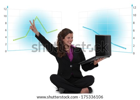 Victorious businesswoman with a laptop