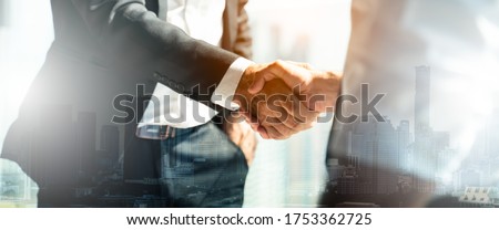 Businessman handshake for teamwork of business merger and acquisition,successful negotiate,hand shake,two businessman shake hand with partner to celebration partnership and business deal concept Royalty-Free Stock Photo #1753362725