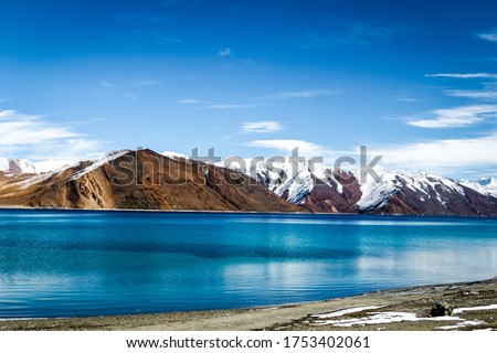 Pangong Lake in Ladakh, India - Snow mountains of Ladakh. Panoramic peak views of Himalayas. Natural beauty of Ladakh in India. Famous tourist place in the world Travel & Landscape photography - Image Royalty-Free Stock Photo #1753402061