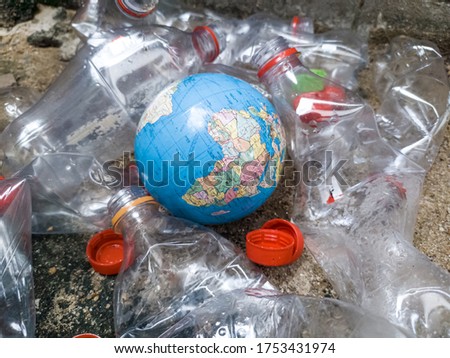 Plastic bottle and little world,Plastics cause global warming.